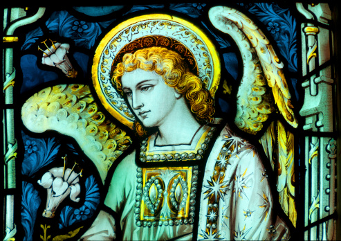 A beautiful nineteenth century stained glass image of an Angel with golden hair.The window adorns the Church of Saint Nicholas, in Newport Shropshire. United Kingdom.