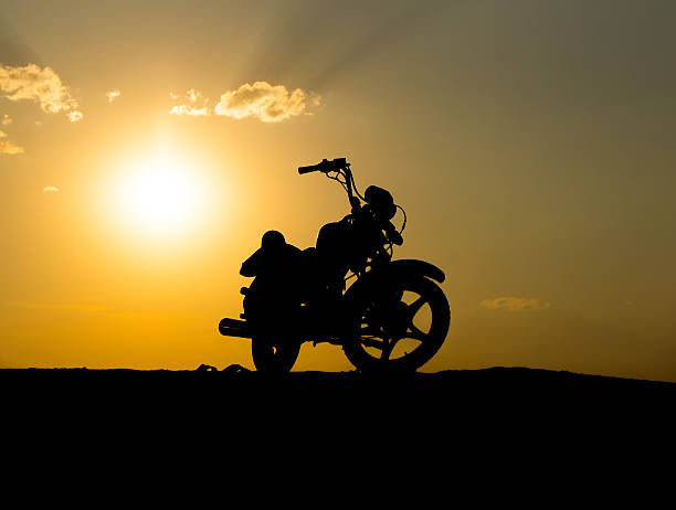 istock Silhouette motorcycl on a background of dark sky 451894653