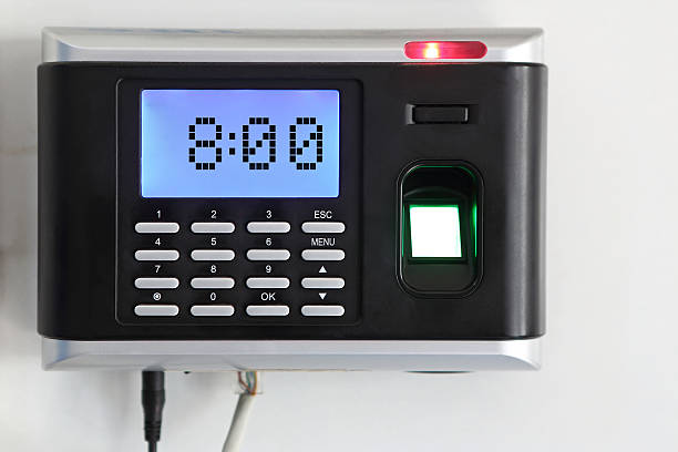 Fingerprint  Scanner A fingerprint scanner that is being used as a time clock. 8:00 o'clock time is displayed on lcd screen. fingerprint scanner photos stock pictures, royalty-free photos & images