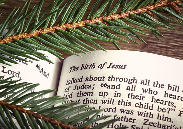 istock Bible open to the Christmas story and pine tree branches 451908777