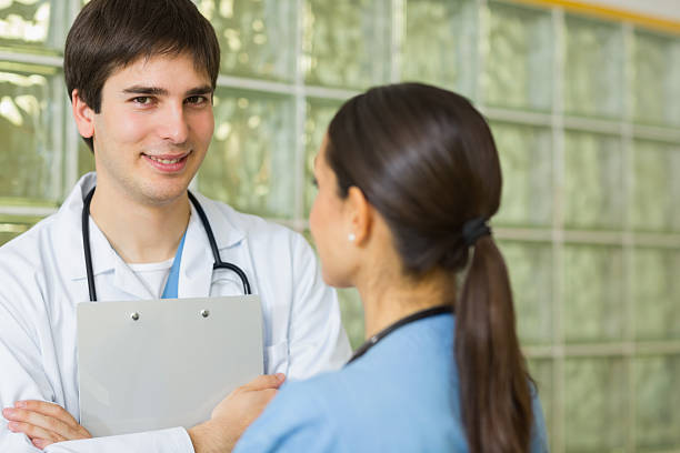 istock Smiling doctor and nurse looking at each other 451909709