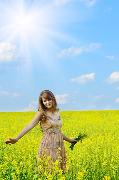 istock Young woman at canola field 451919457
