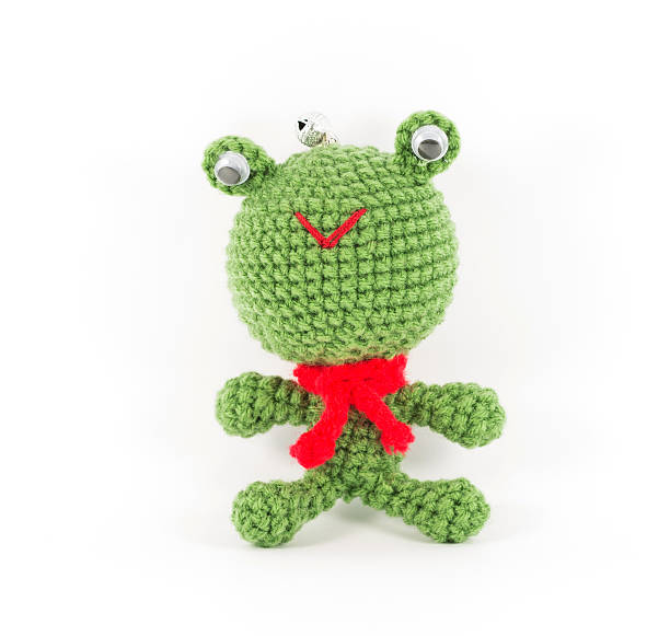 istock handmade crochet green frog doll on white background 451923027