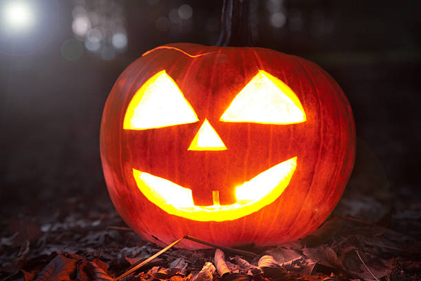 istock Halloween pumpkins in a forest at night 451926877