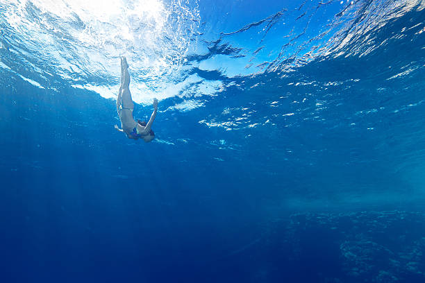istock girl diving in sunbeams 451937121