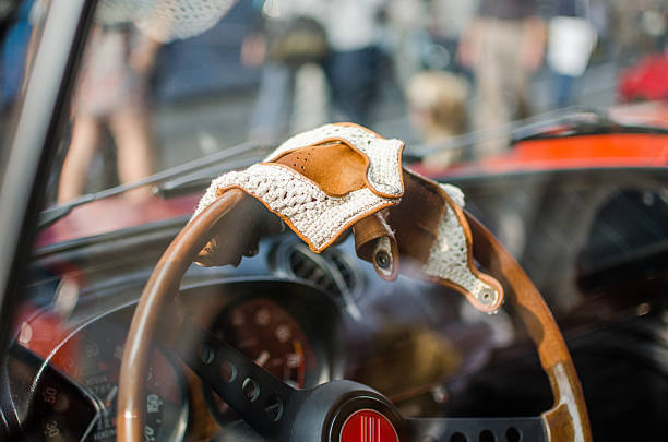 Racing gloves Racing Gloves on a 1963 Autobianchi Bianchina Cabriolet porsche classic sports car obsolete stock pictures, royalty-free photos & images