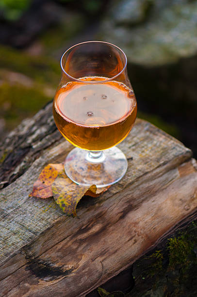 A lime is dropped into a glass of beer.