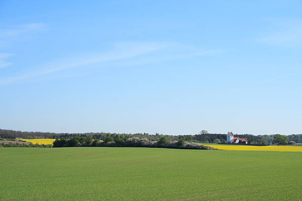 istock Idyllic country side parish church behind oilseed rape field 451963059