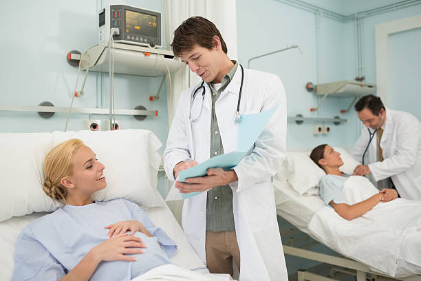 istock Obstetrician talking to a patient lying in bed 451964161
