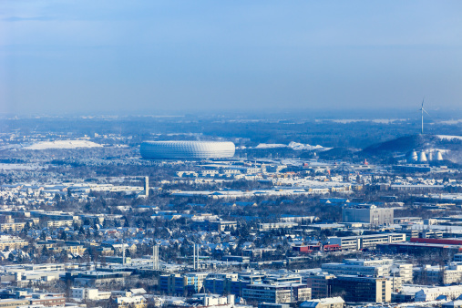 Munich seen from above after a snowfall. On the background you can see the Allianz Arena Stadium. Germany.