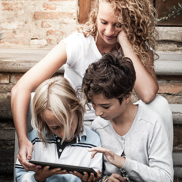 istock Young Woman and Children Using Tablet PC 451964807