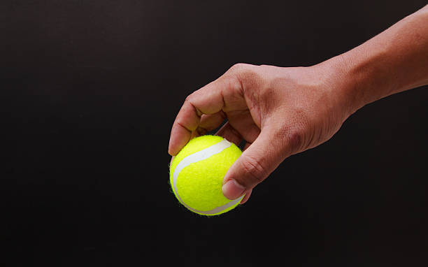 istock Hand put tennis ball 451968825