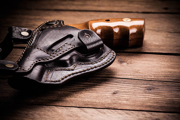 istock pistol on a wood background 451974725