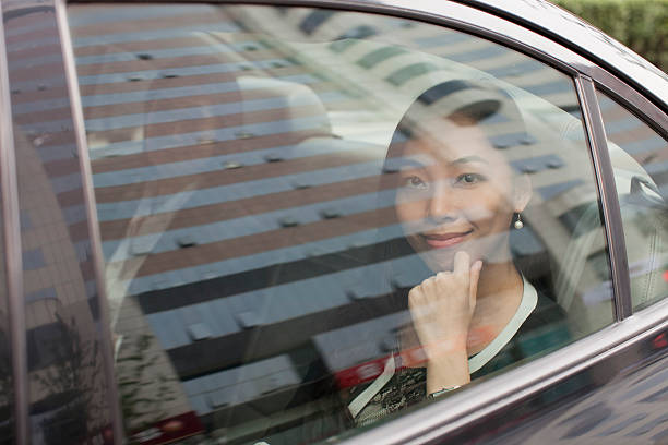 istock Smiling Businesswoman in Car Back 451982605