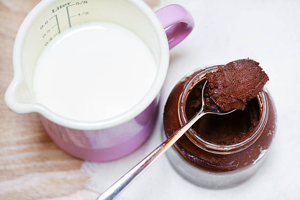 Carob cocoa vegan spread, rawtella, homemade, milk jug stock photo