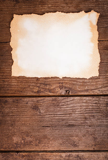 istock aged paper on wood 451983553