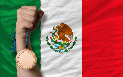 Holding bronze medal for sport and national flag of mexico