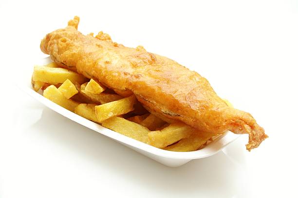 istock traditional British fish and chips on retail tray 451983673