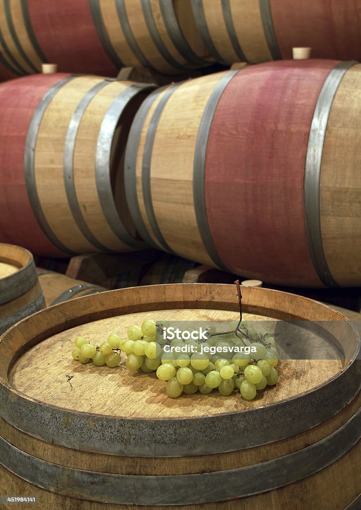 Bunch of grapes on the barrel An image from a winery cellar Acid Stock Photo