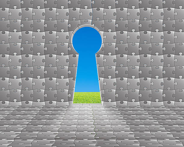 istock Key hole shape door on puzzles wall with meadow, sky 451986555