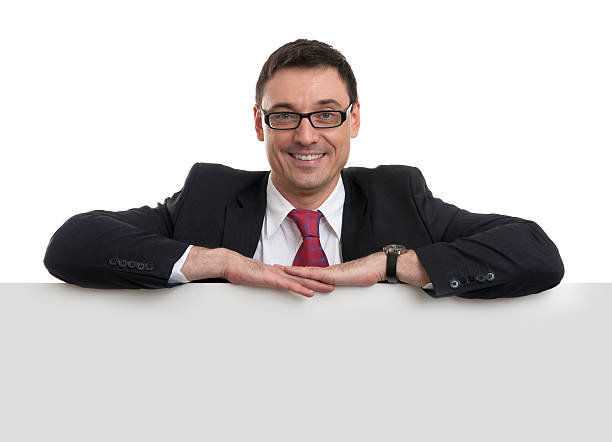 istock smiling young business man showing blank signboard 451986559
