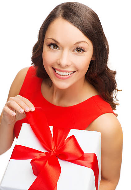istock smiling woman in red dress with gift box 451992035