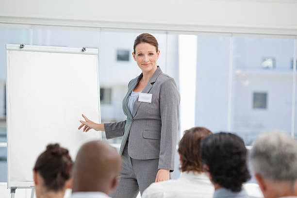 istock Serious businesswoman pointing towards a chart during the presentation 451994125