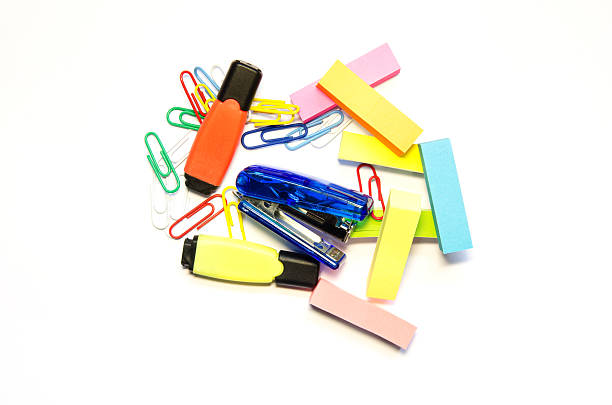 Blue stapler, colored paper clips, Two markers  and stick isolate stock photo