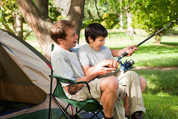 istock Little boy learning fishing with his father 451994985