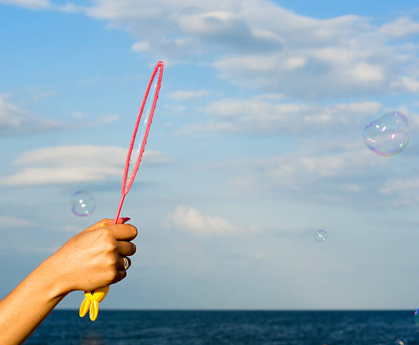 istock Colorful Soap Bubbles Against Blue Sky Background 451996699