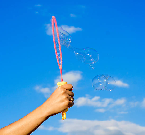 istock Colorful Soap Bubbles Against Blue Sky Background 452010391