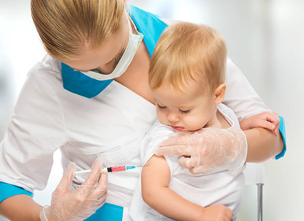 Small child having an injection from a nurse wearing gloves A doctor does injection child vaccination baby injecting flu virus vaccination child stock pictures, royalty-free photos & images