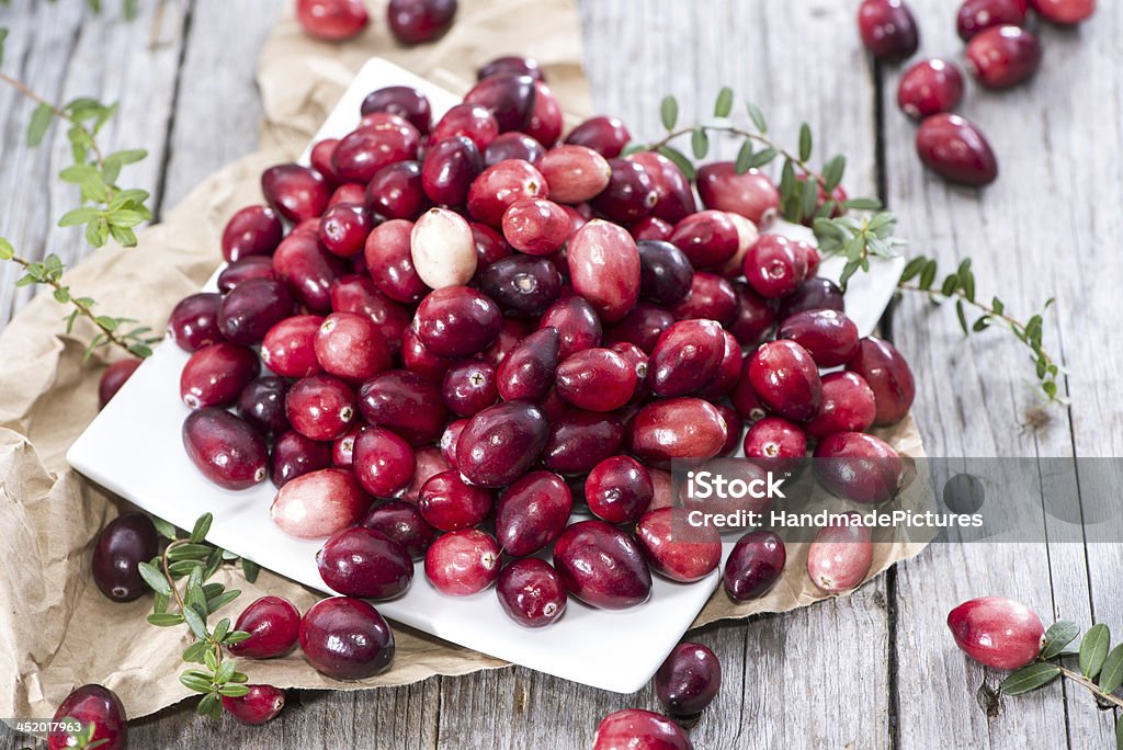 Portion of fresh Cranberries Portion of fresh Cranberries (on wooden background) Berry Stock Photo