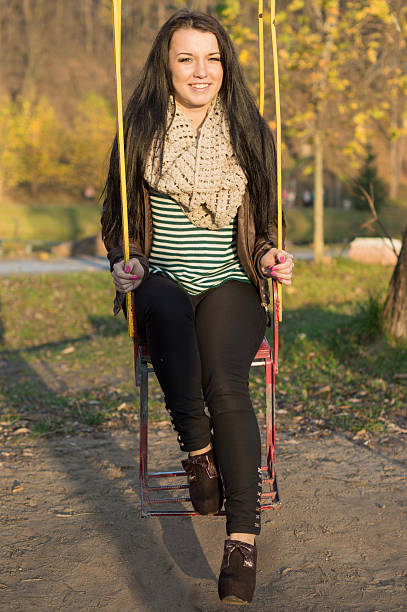 istock young model relaxing in a sunny garden sitting on swing 452018231