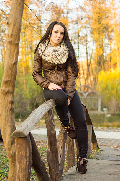 istock Young pretty woman in autumn park 452022117