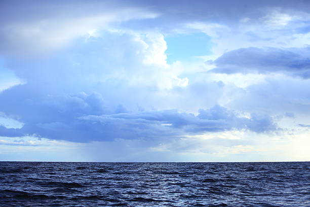 istock Cloudy dark sky above a surface of the sea 452026599