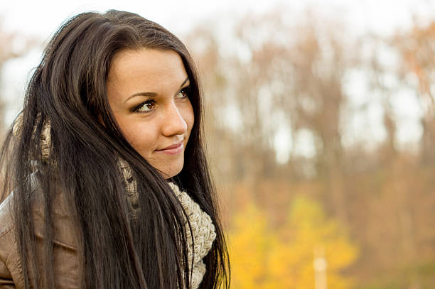 istock Young pretty woman in autumn park 452030495