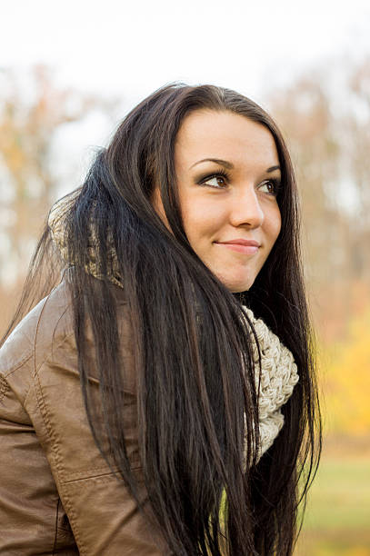 istock Young pretty woman in autumn park 452030497