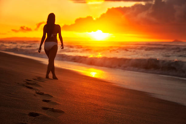 istock Attractive Young Woman in White Bikini Walking on Hawaiian Beach 452033427