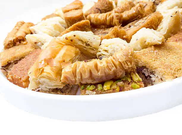 variety of sweetmeats with honey, chopped pistachios and walnuts