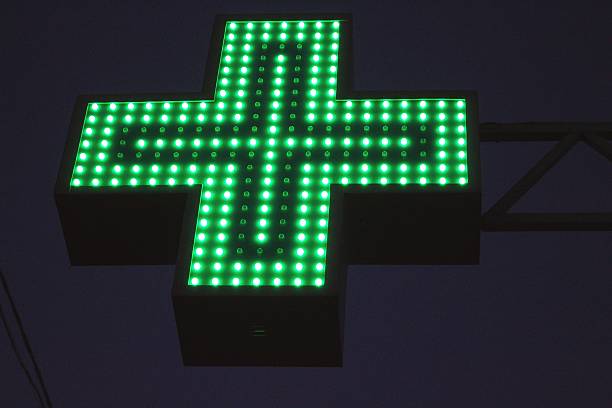 istock Neon green cross sign 452046323