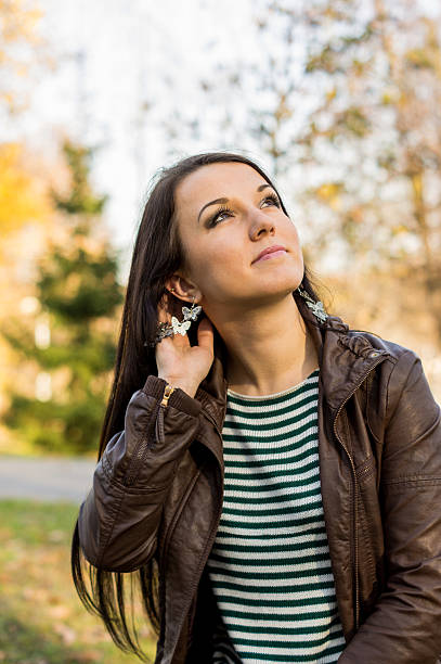 istock Young pretty woman in autumn park 452050037