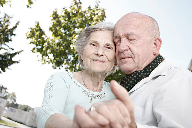 Senior couple dancing in the park stock photo