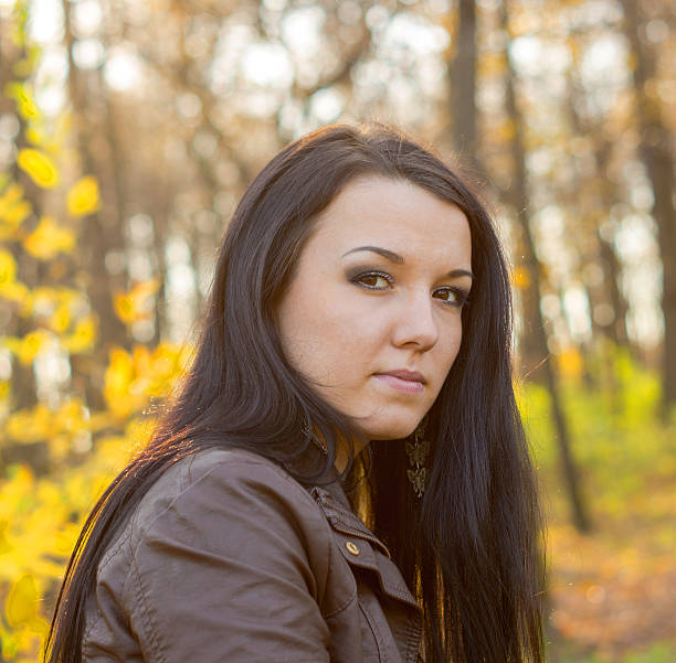 istock Young pretty woman in autumn park 452052703