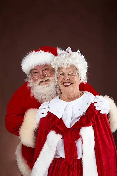 A vertical portrait of the real santa and Mrs. Claus.