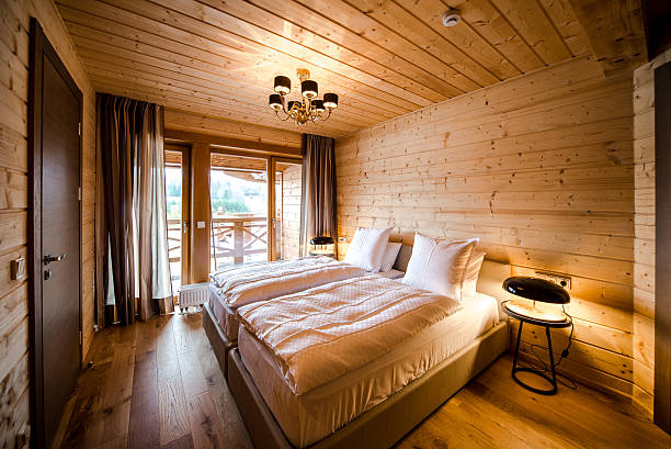 istock Cute wooden bedroom with two single bed and warm lighting 452070637