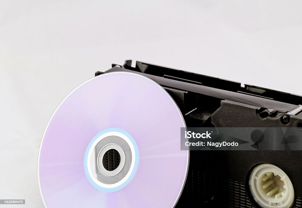VHS and DVD VHS video tape and DVD disk (analog digital) on white background DVD Stock Photo