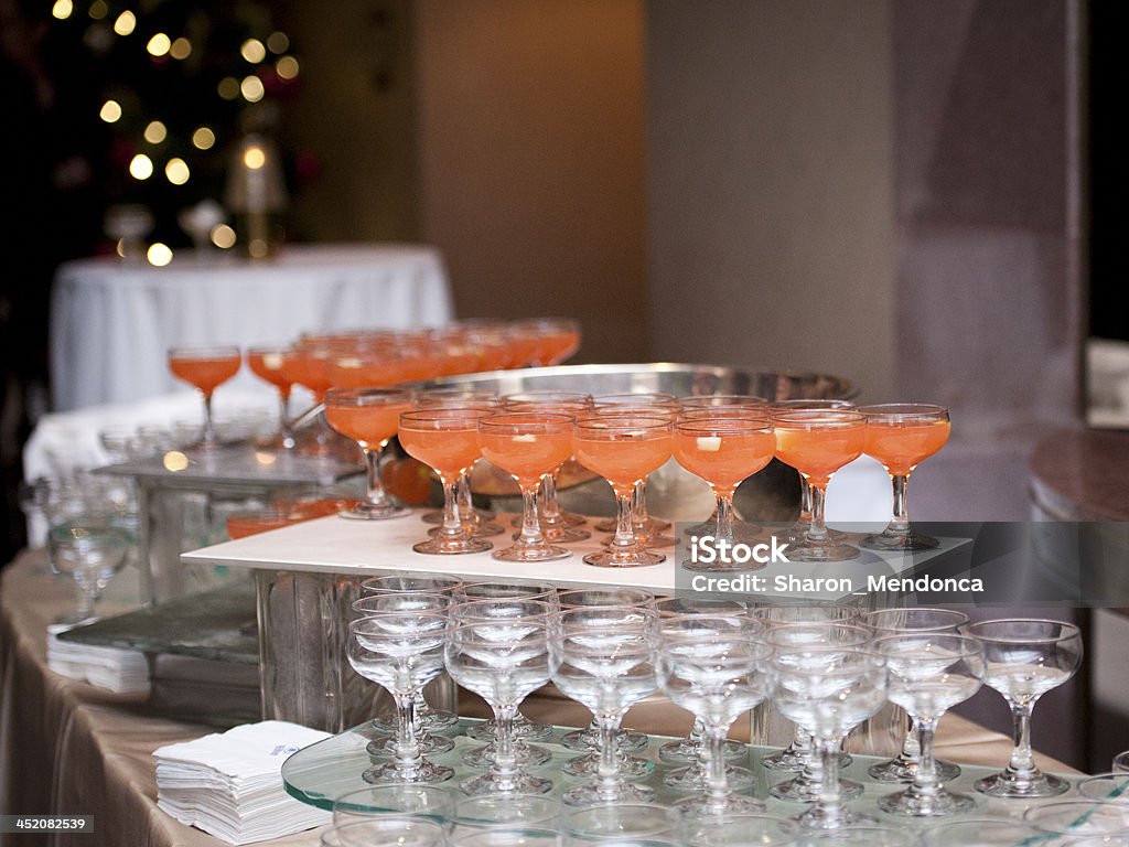 Fruit Punch at a Party Glasses of fruit punch ready for guests at a workplace holiday party. Punch Bowl Stock Photo