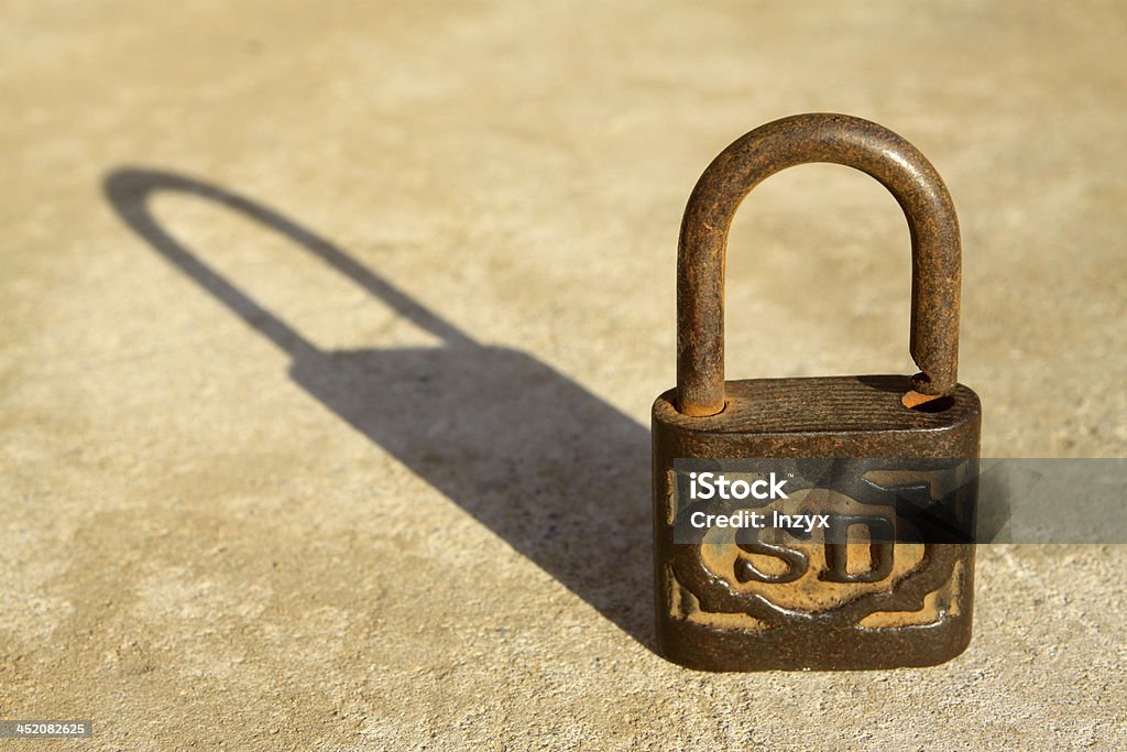 rusty lock close up of rusty lock on gray background Book Stock Photo