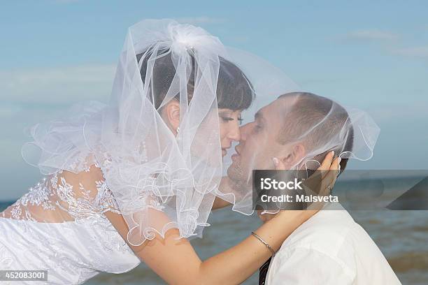 Bride And Groom Gentle Kiss Stock Photo - Download Image Now - Blue Background, Bride, Veil